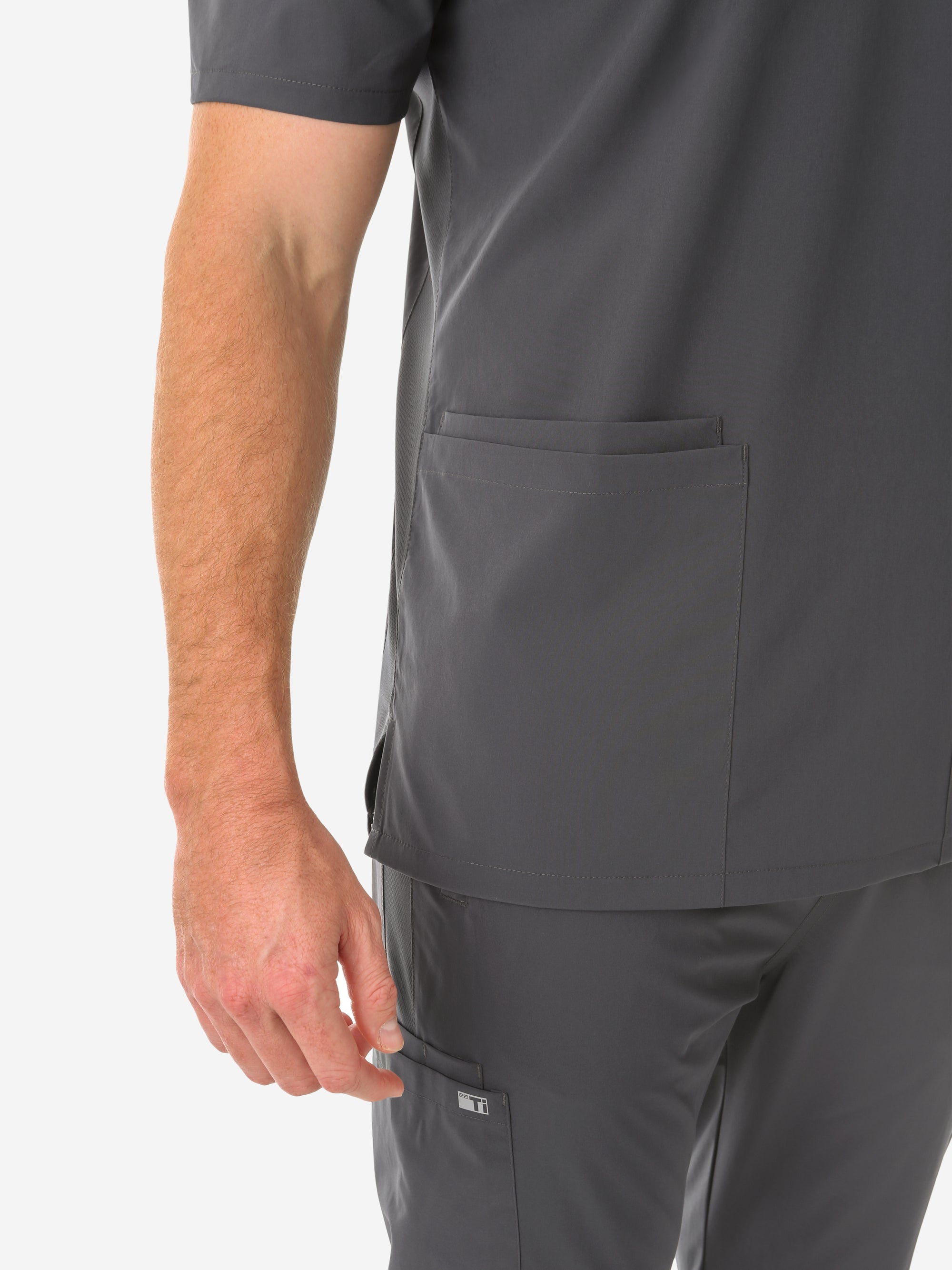 Men's Charocal Gray Five-Pocket Scrub Top Full Body Lower Pockets Closeup