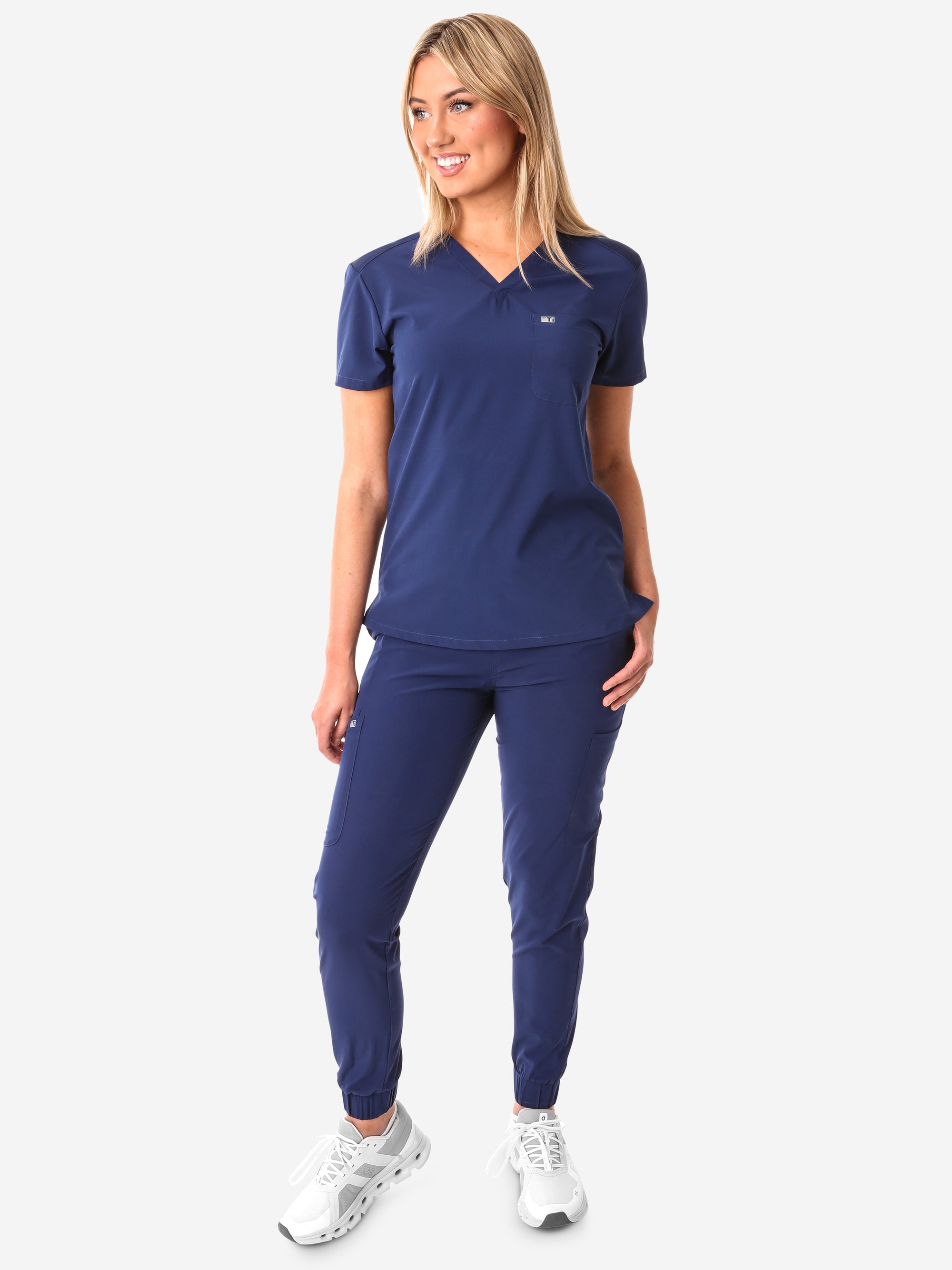 TiScrubs Women's Stretch Navy Blue One-Pocket Scrub Top Untucked and Joggers Front View Full Body