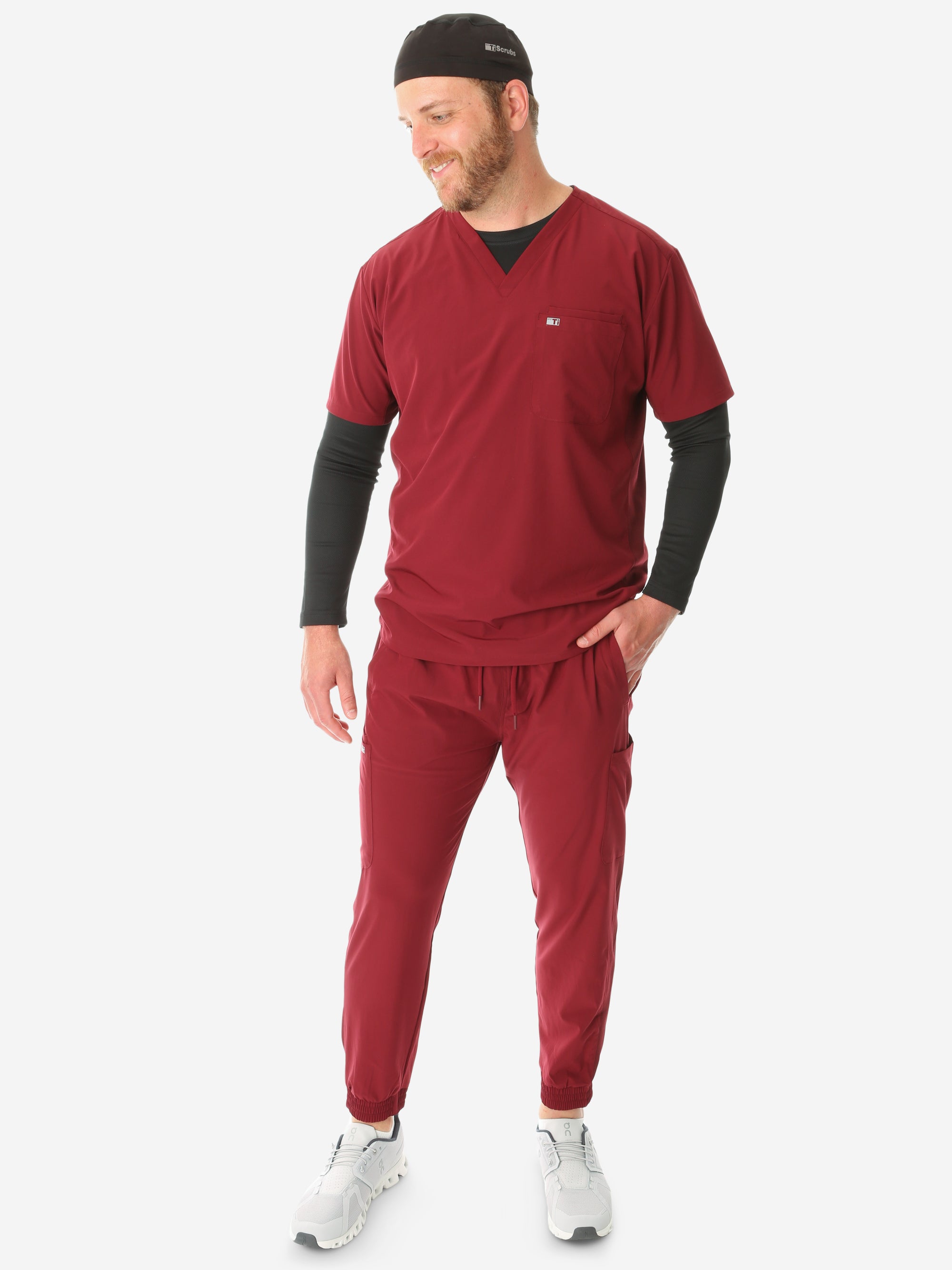 TiScrubs Stretch Men's Bold Burgundy Stretch Jogger Scrub Pants and Double-Pocket Top Untucked Long Sleeve Black Underscrub and Scrub Cap Full Body Front