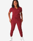 TiScrubs Women's Stretch Bold Burgundy One-Pocket Tuckable Scrub Top and 9-Pocket Pants Untucked Full Body Front