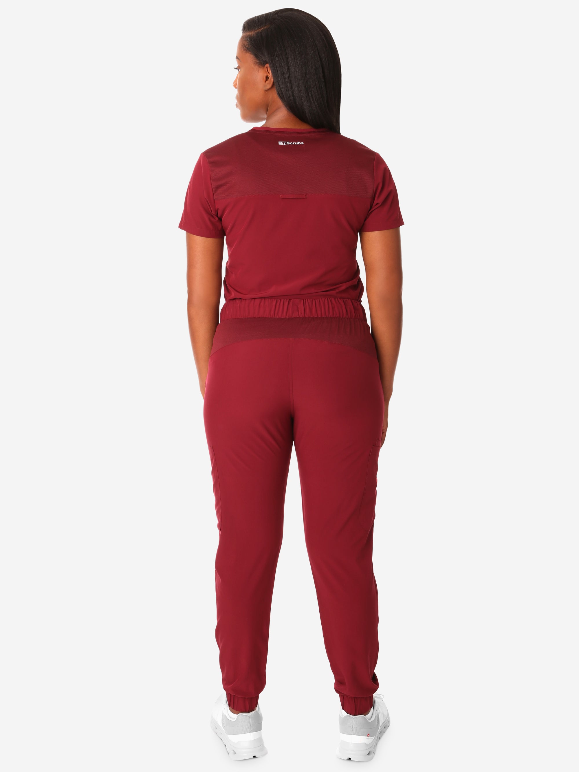TiScrubs Women's Stretch Bold Burgundy One-Pocket Tuckable Scrub Top and 9-Pocket Pants Tucked  Full Body Back