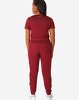 TiScrubs Women's Stretch Bold Burgundy One-Pocket Tuckable Scrub Top and 9-Pocket Pants Tucked Full Body Back