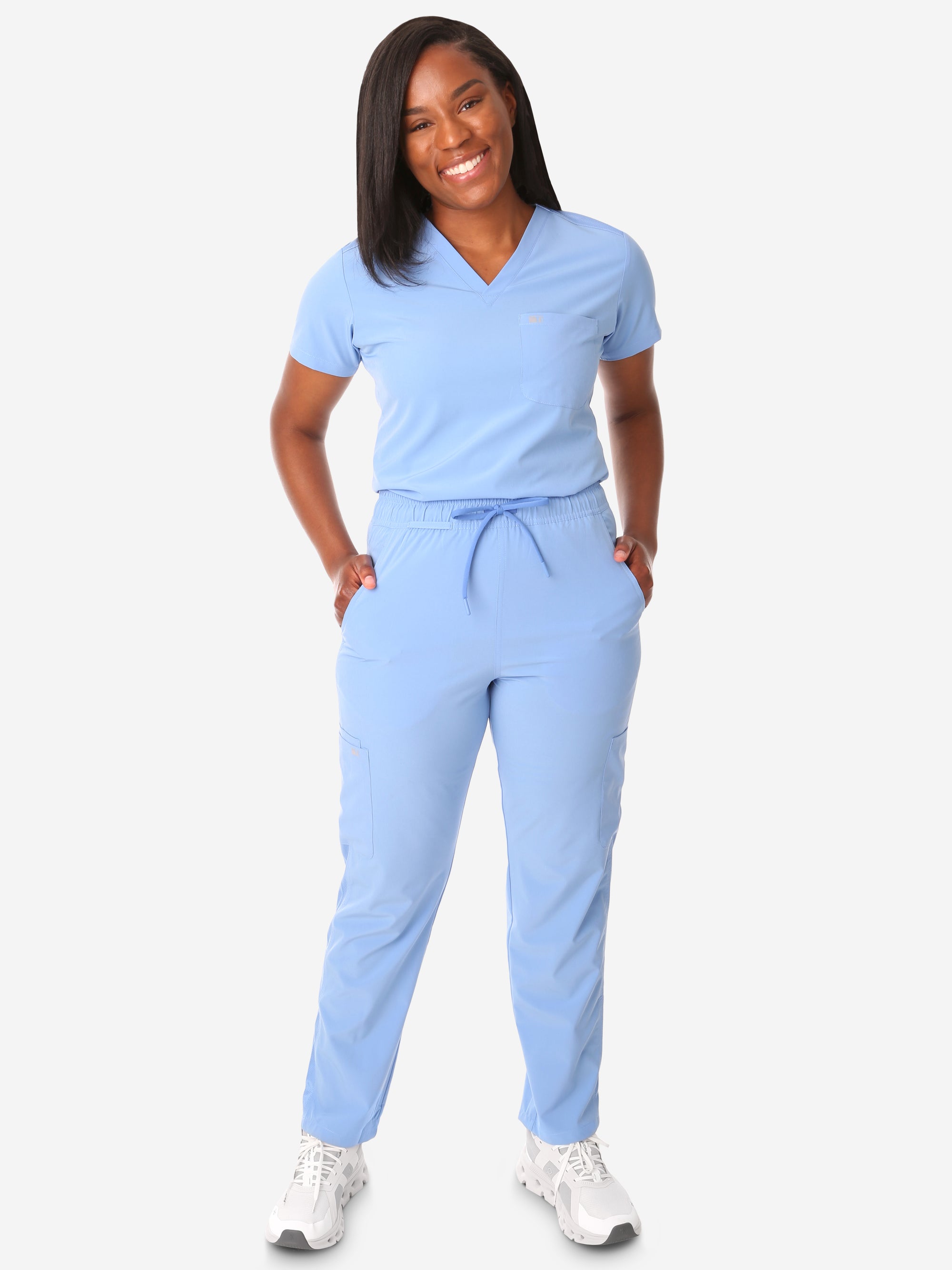 TiScrubs Women's Stretch Ceil Blue One-Pocket Tuckable Scrub Top and 9-Pocket Pants Tucked  Full Body Front