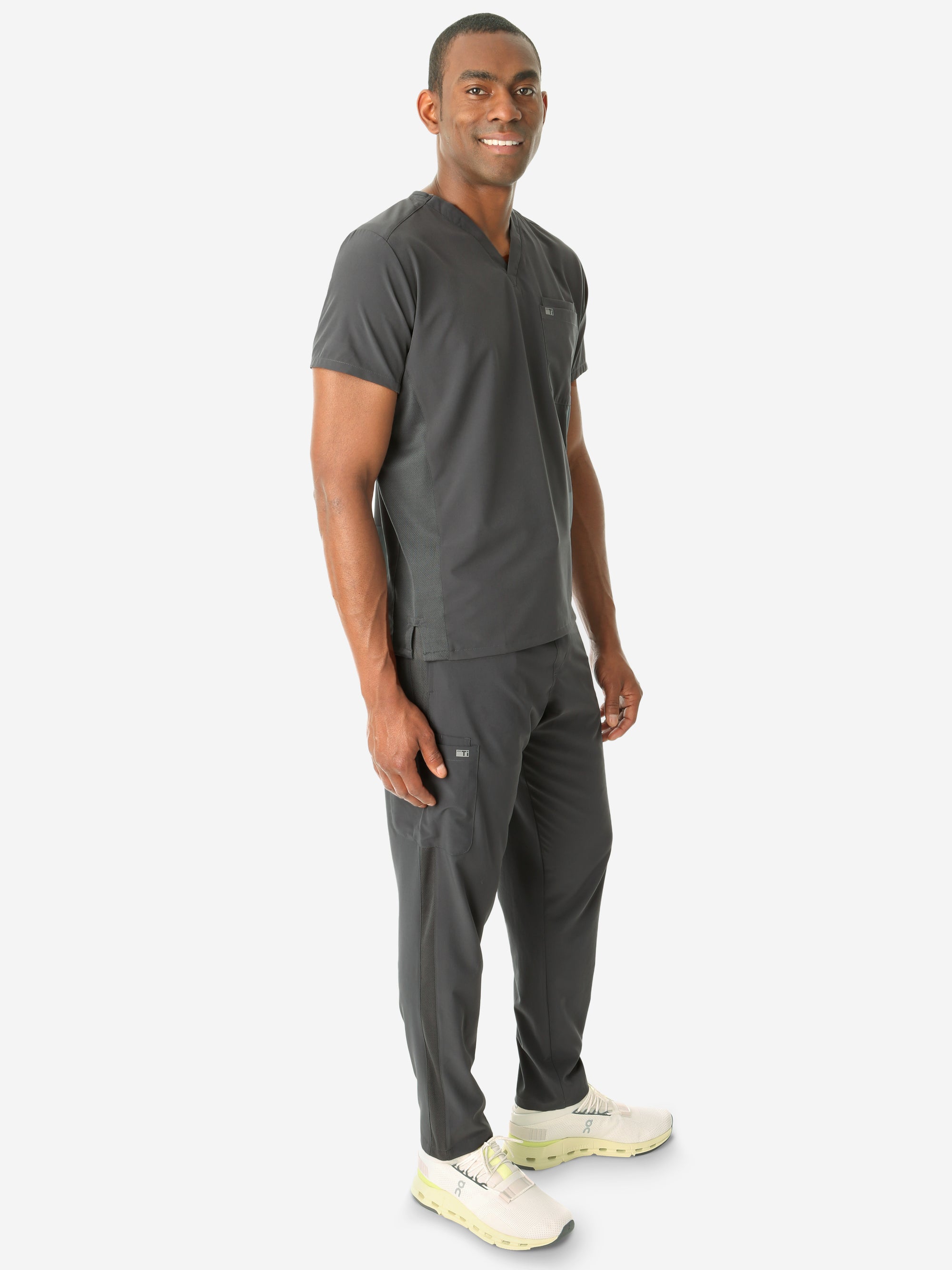 Men's Double Pocket Scrub Top Untucked Charcoal Gray Full Body Side View with 9-Pocket Pants