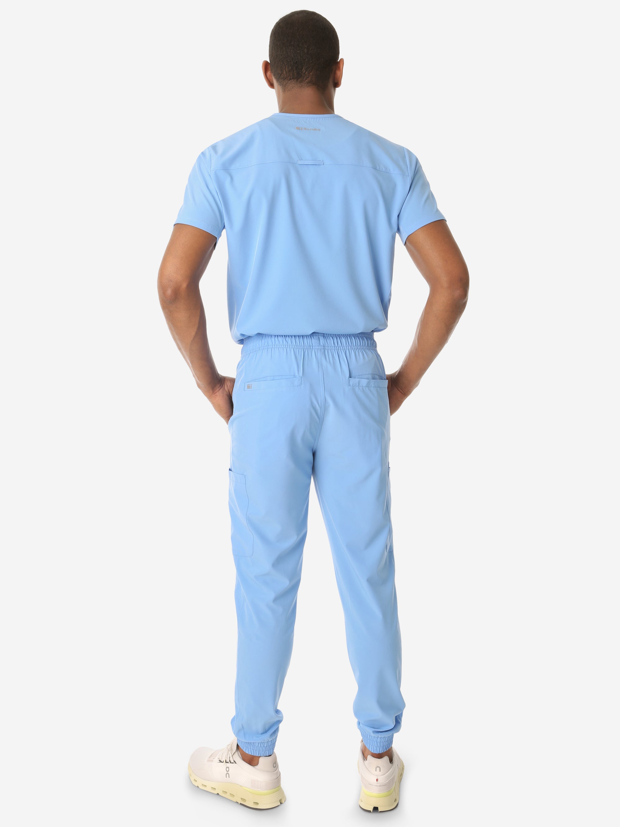 TiScrubs Men's Ceil Blue Double-Pocket Scrub Top Tucked and Joggers Full Body Back