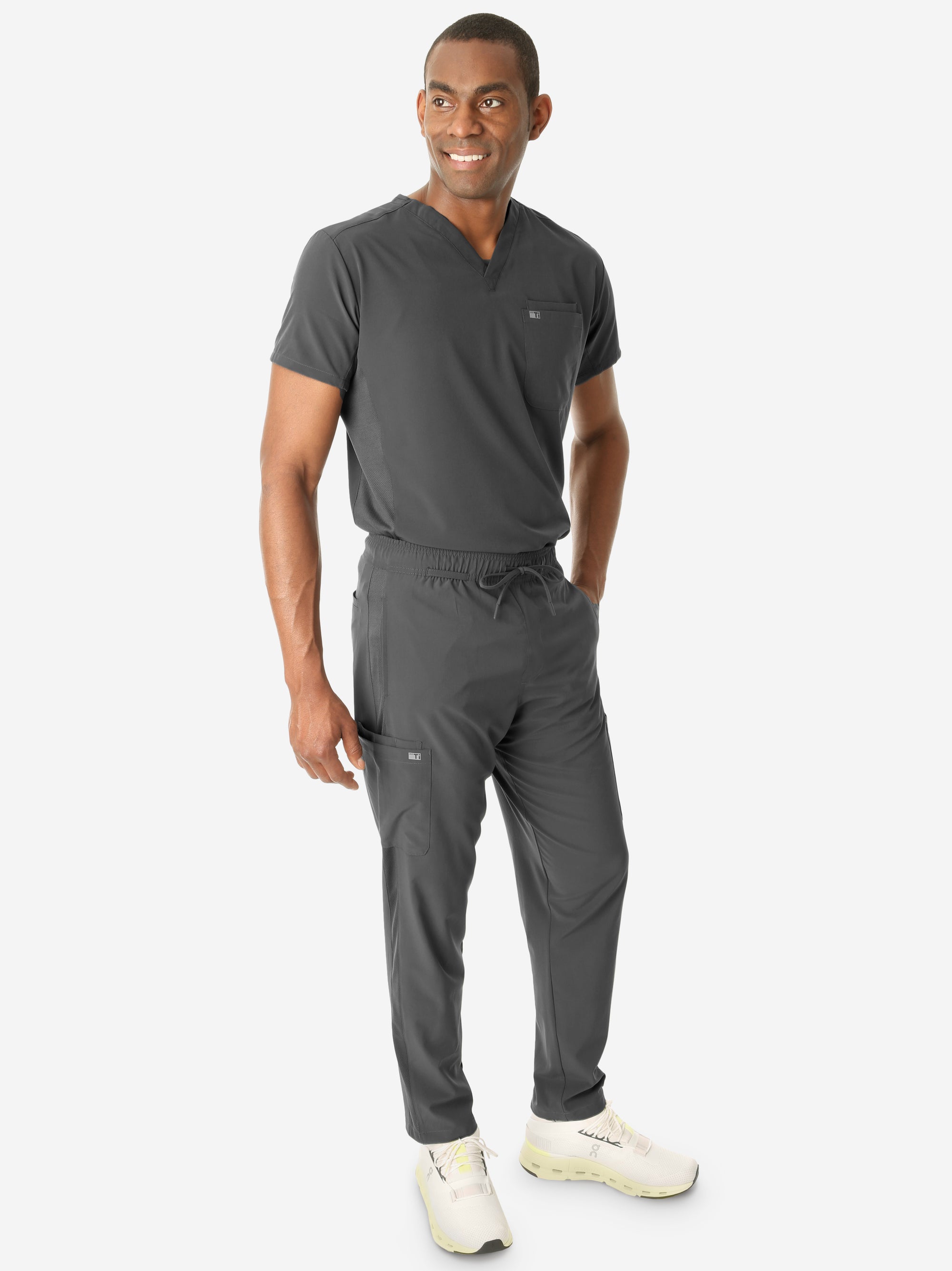 Men's Double-Pocket Scrub Top Charcoal Gray Tucked with 9-Pocket Scrub Pants Front