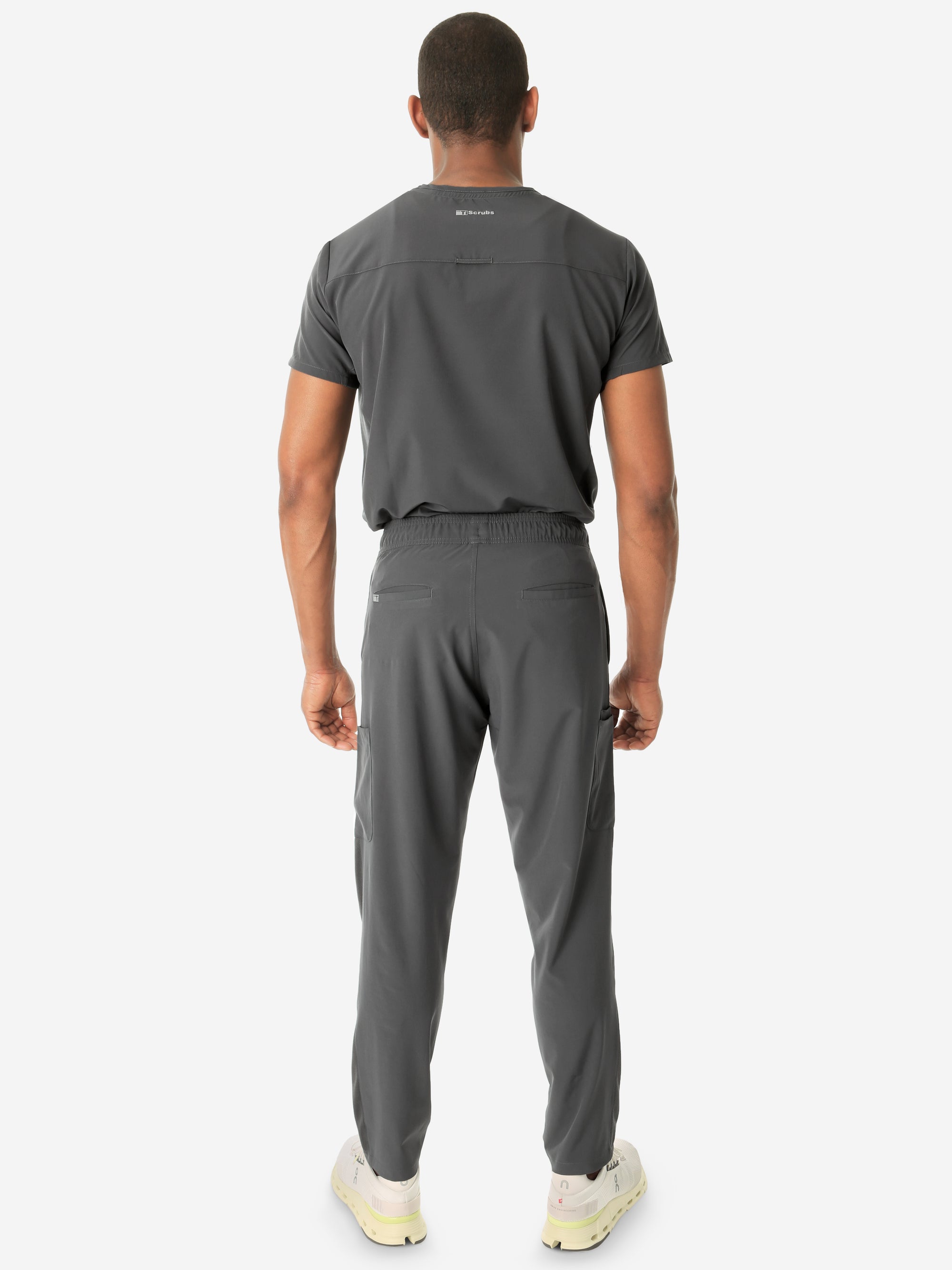 Men's Double-Pocket Scrub Top Charcoal Gray Tucked with 9-Pocket Scrub Pants Back View