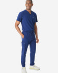 Men's Double-Pocket Scrub Top Navy Blue Tucked Side View with 9-Pocket Pants