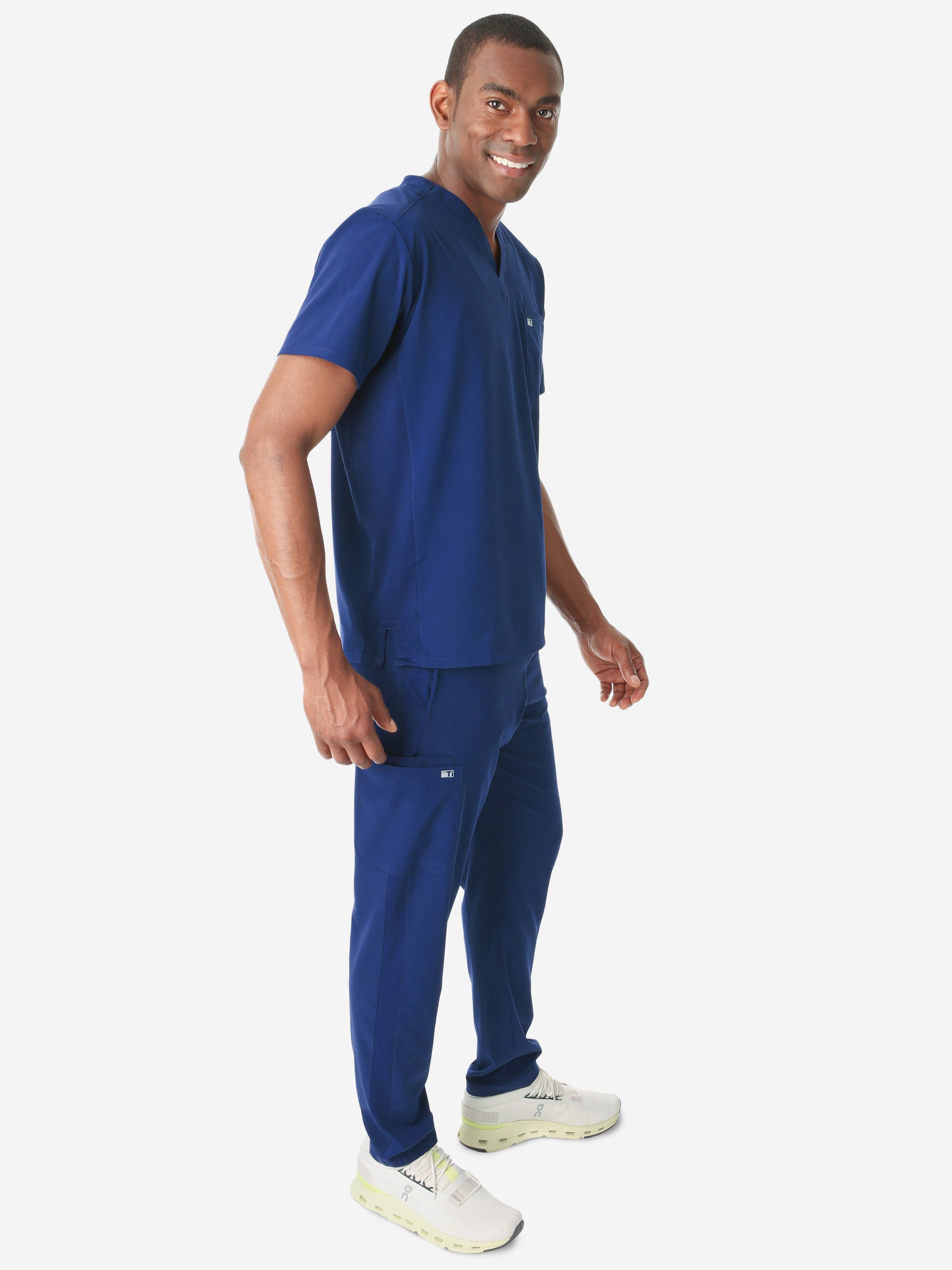 Men's Double-Pocket Scrub Top Navy Blue Untucked Side View with 9-Pocket Pants