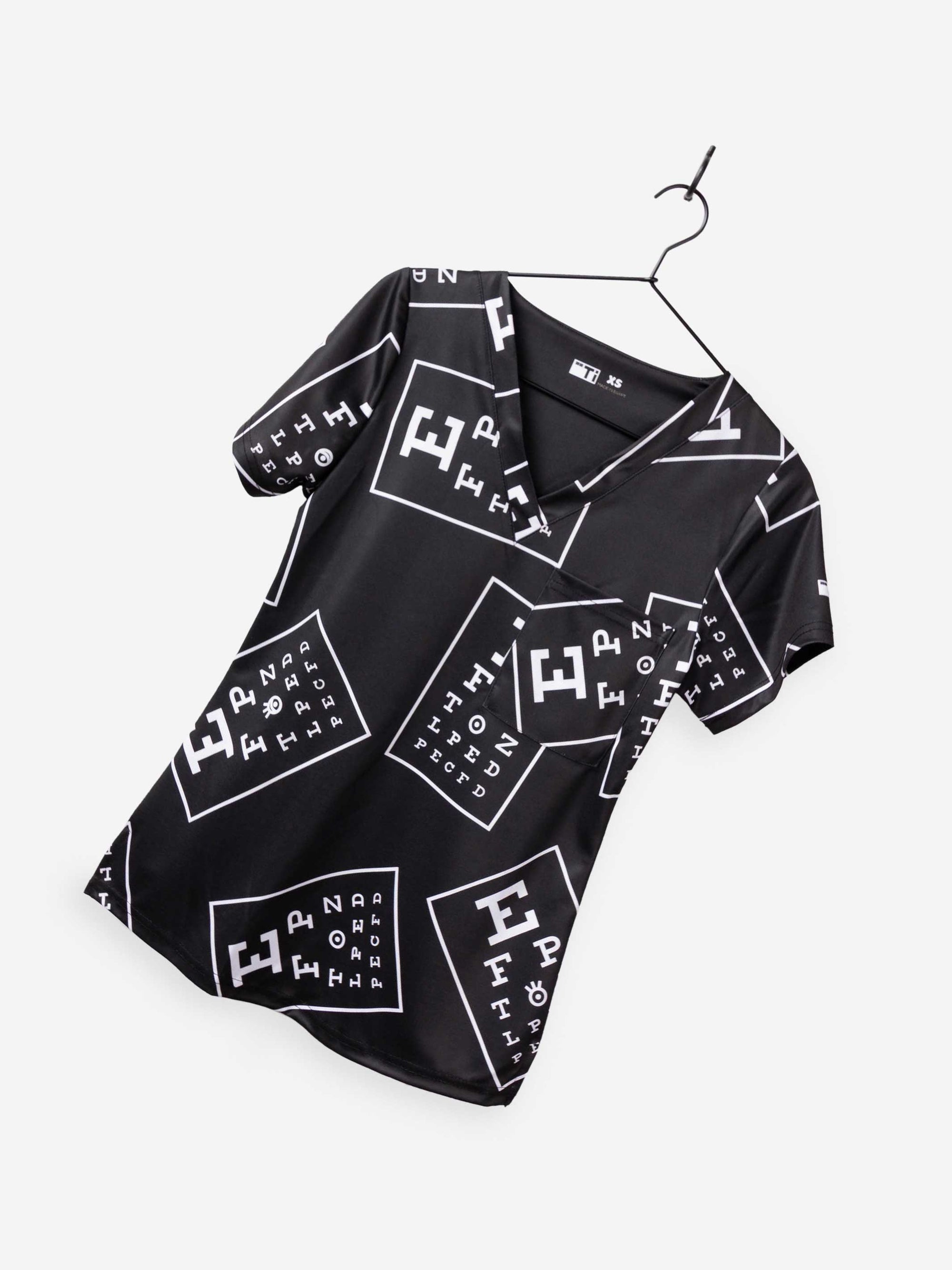 women's ophthalmology print scrub top black with white eye charts vision print