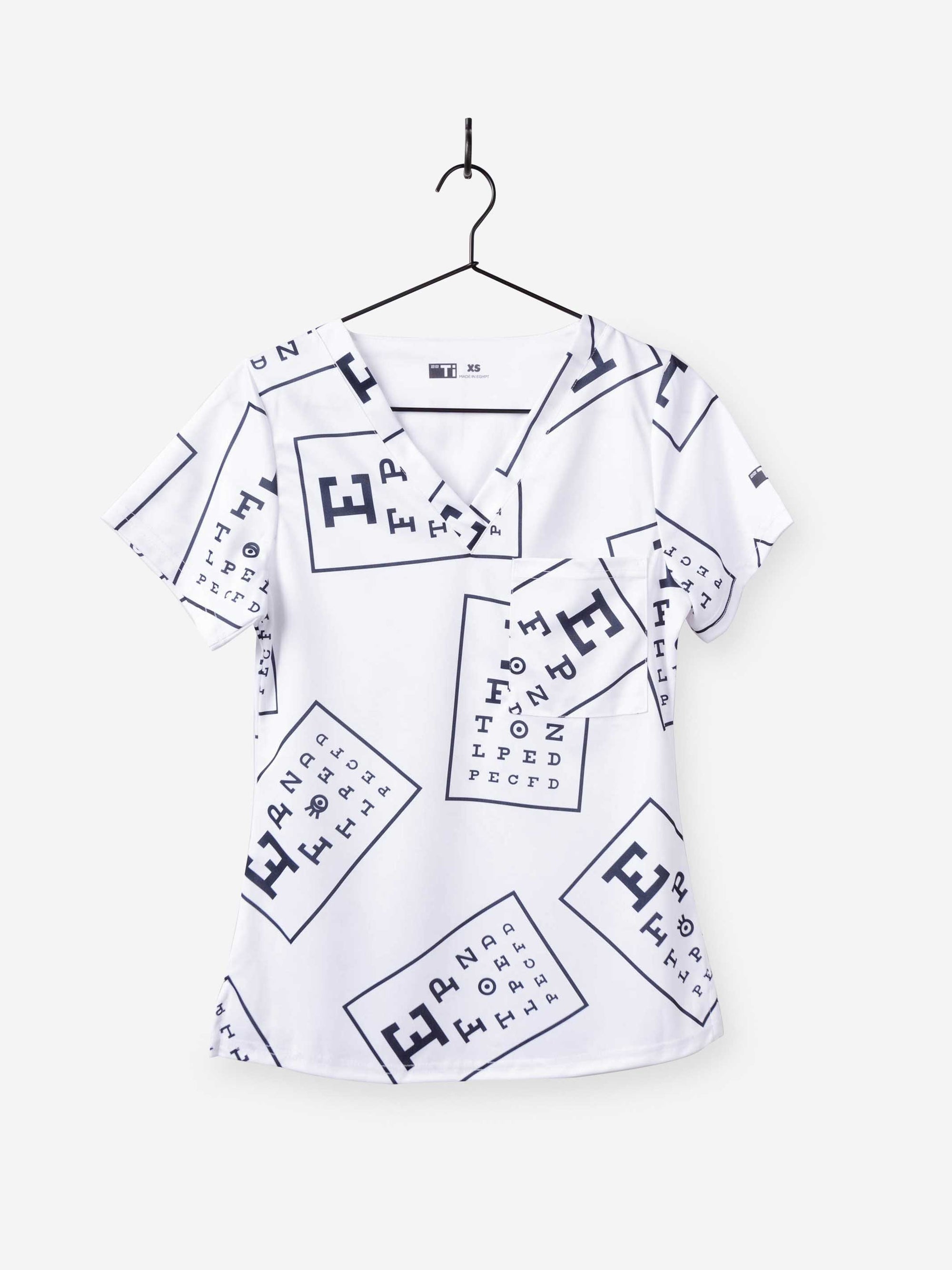 women's ophthalmology print scrub top white with black eye charts print
