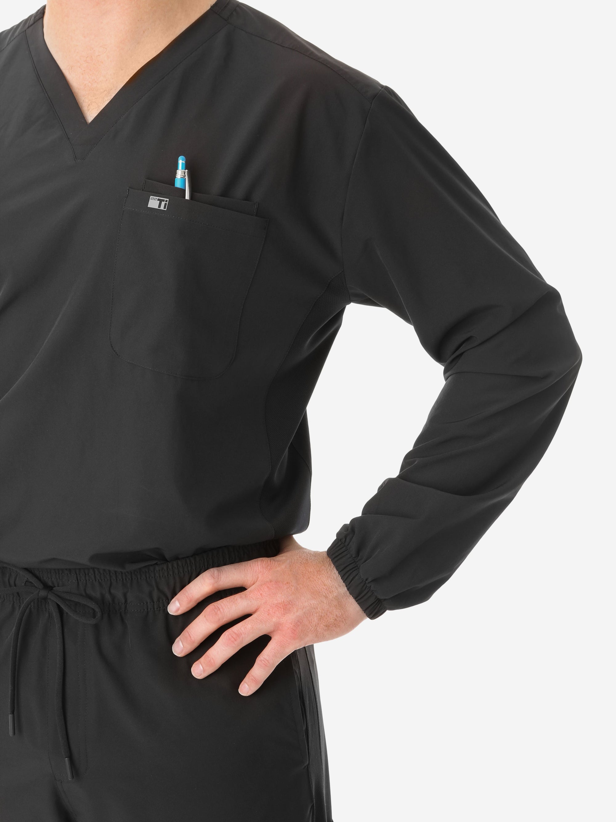 Men&#39;s Long Sleeve Scrub Top with Two Chest Pockets Real Black Front View Pockets Closeup