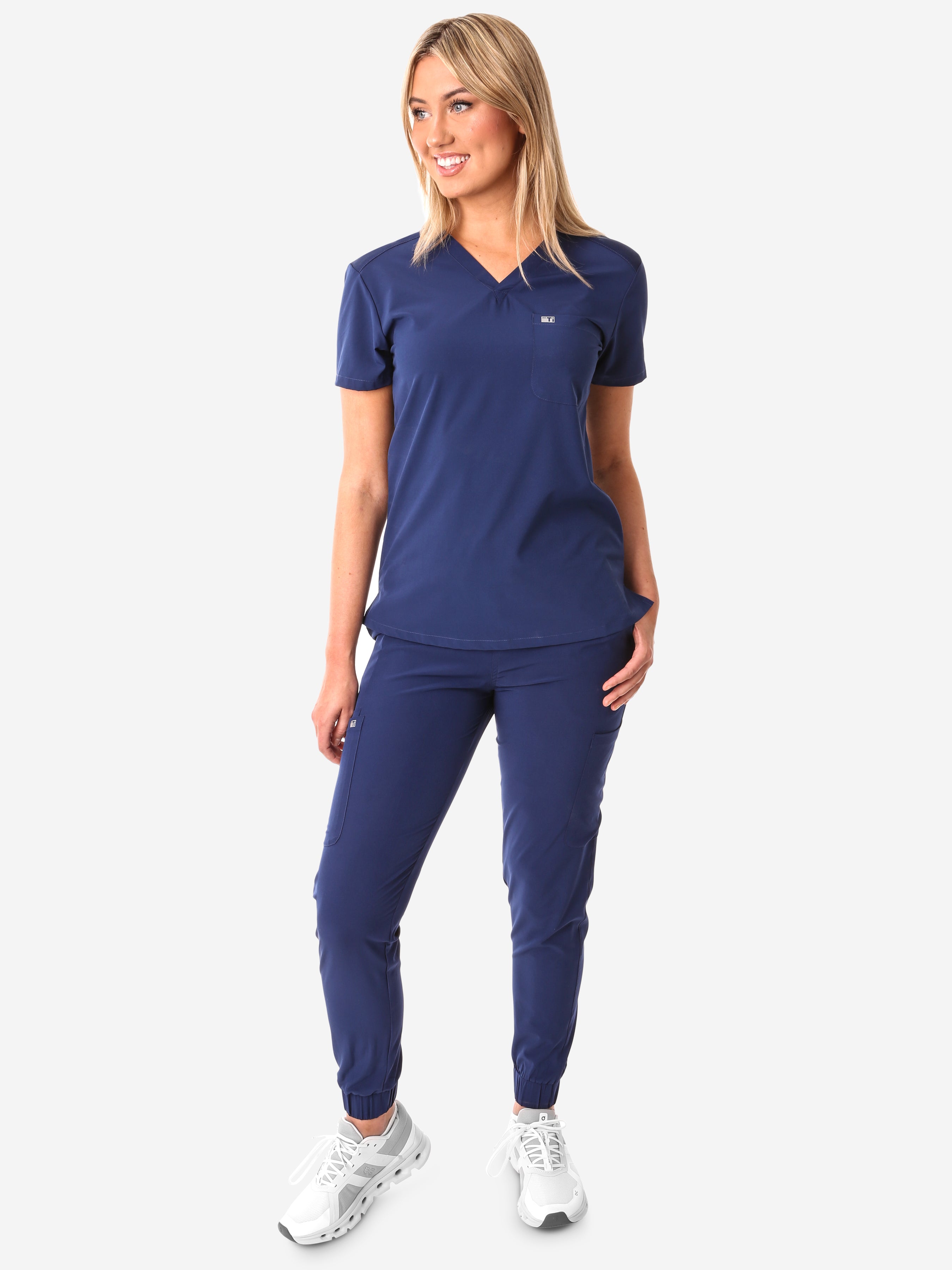 TiScrubs Women&#39;s Stretch Navy Blue One-Pocket Scrub Top Untucked and Joggers Front View Full Body
