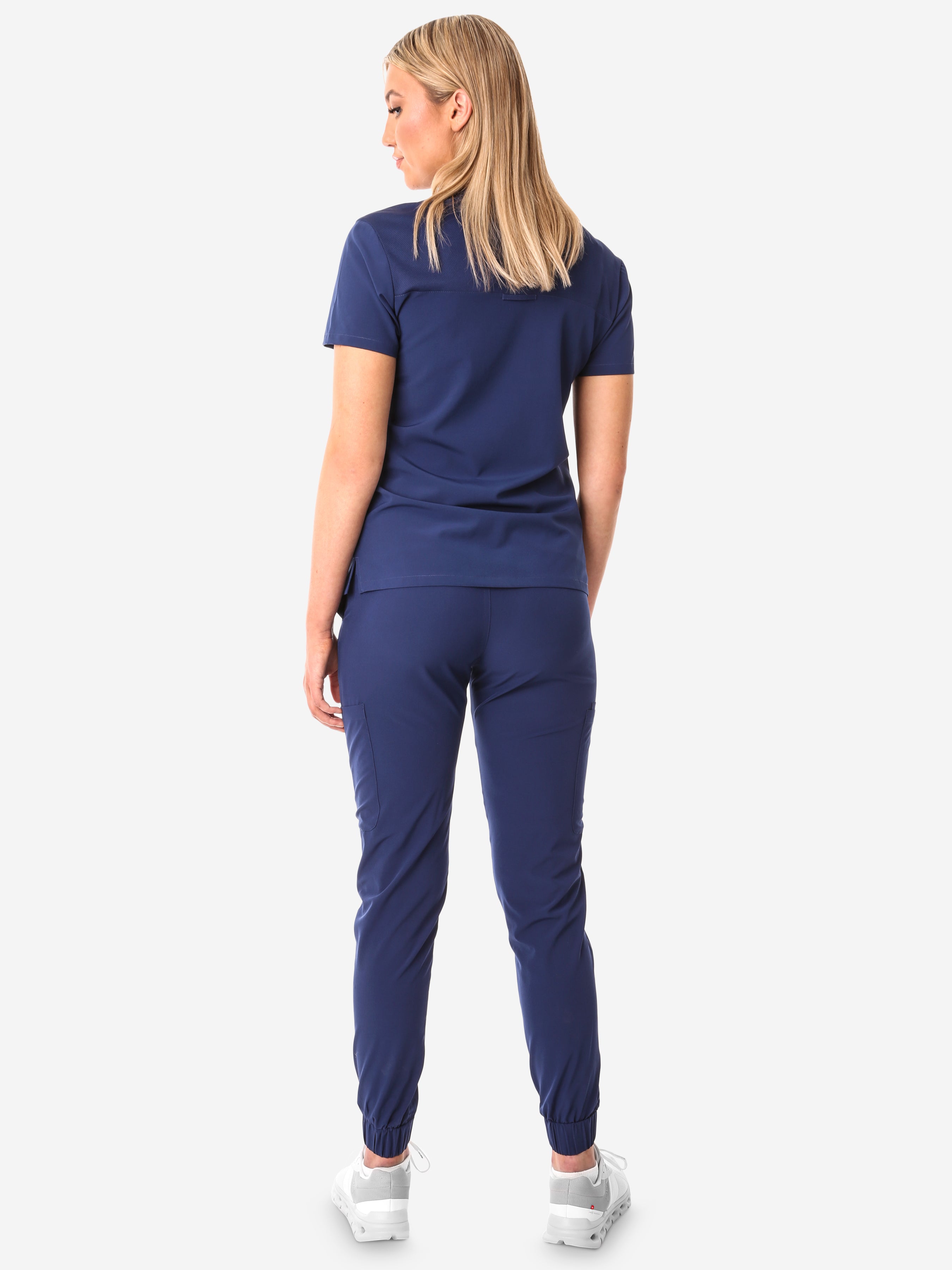 TiScrubs Women&#39;s Stretch Navy Blue One-Pocket Scrub Top Untucked and Joggers Back View Full Body