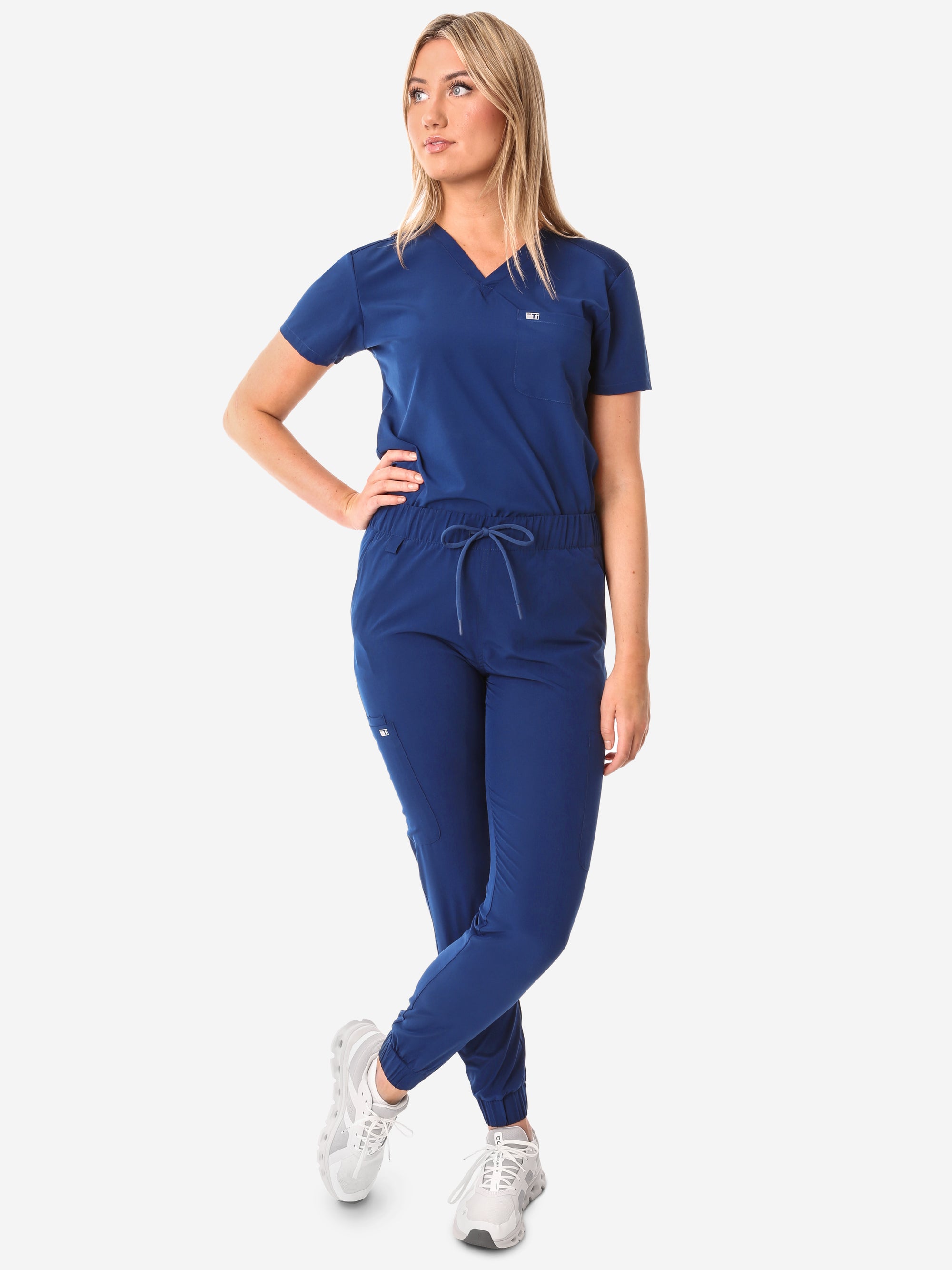 Women&#39;s Navy Blue Perfect Scrub Joggers Full Body Front with One-Pocket Scrub Top Tucked