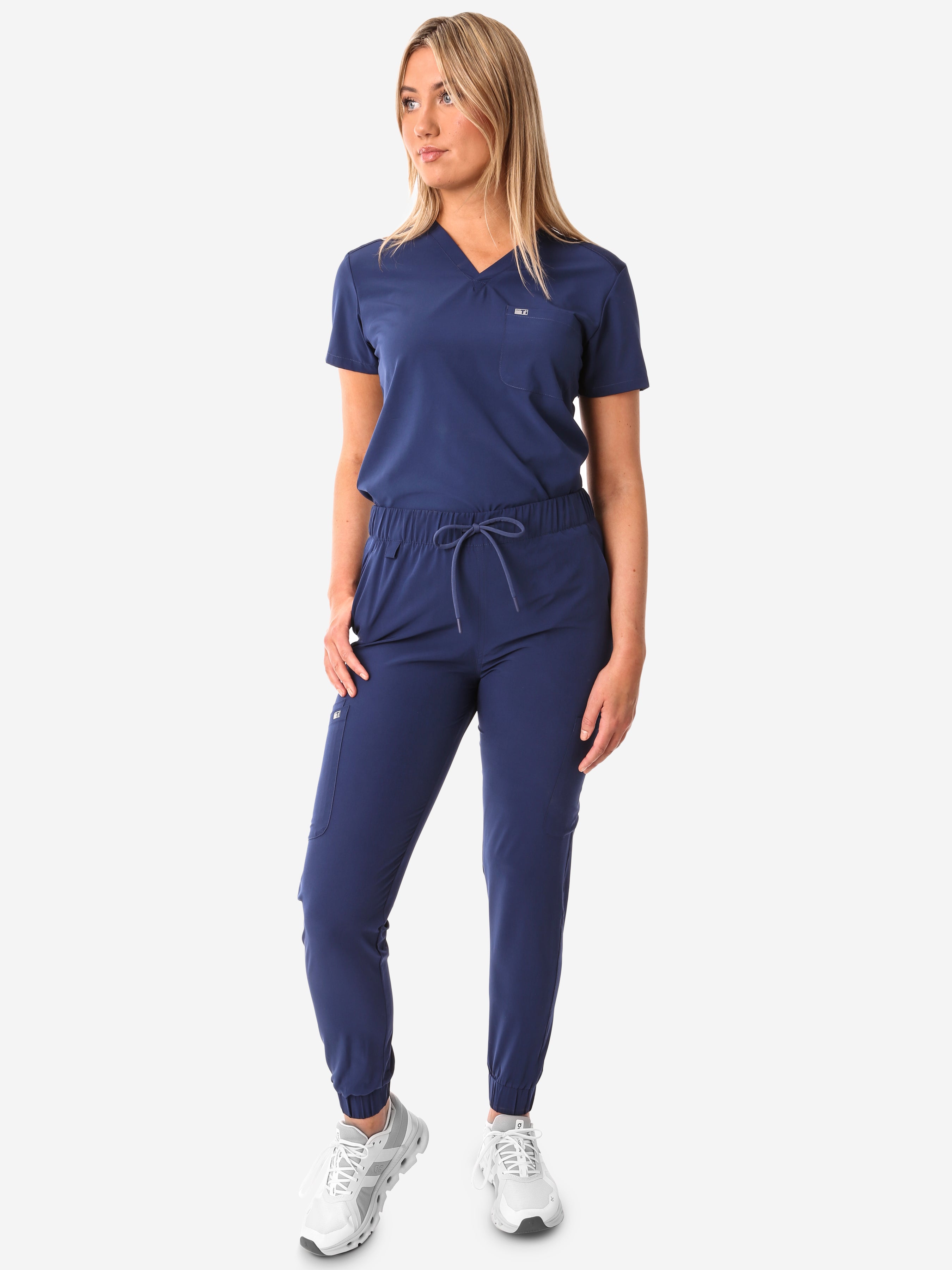 TiScrubs Women&#39;s Stretch Navy Blue One-Pocket Scrub Top Tucked and Joggers Front View Full Body