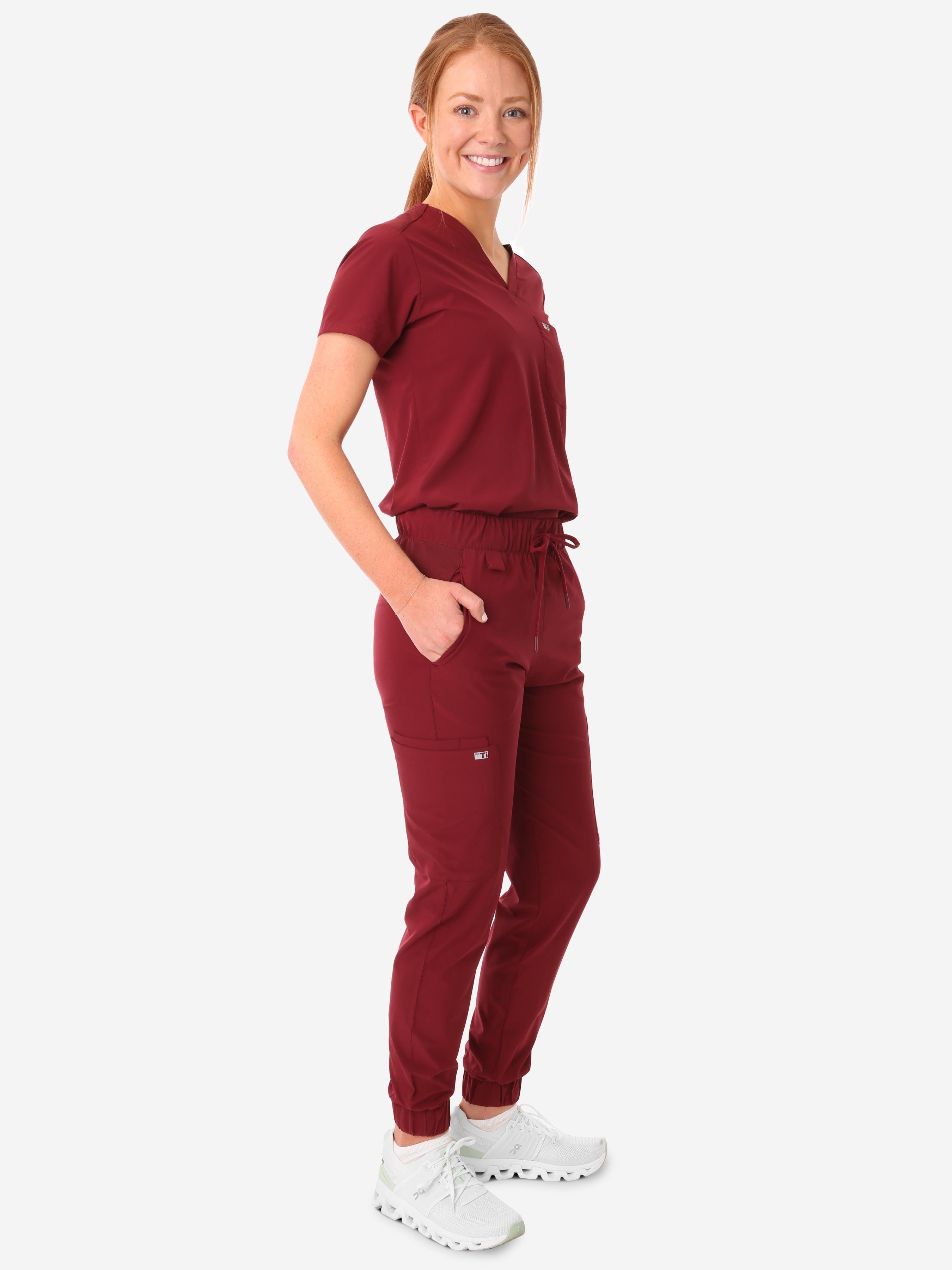TiScrubs Bold Burgundy Women&#39;s Stretch Perfect Jogger Pants and One-Pocket Tuckable Top Side View Full Body