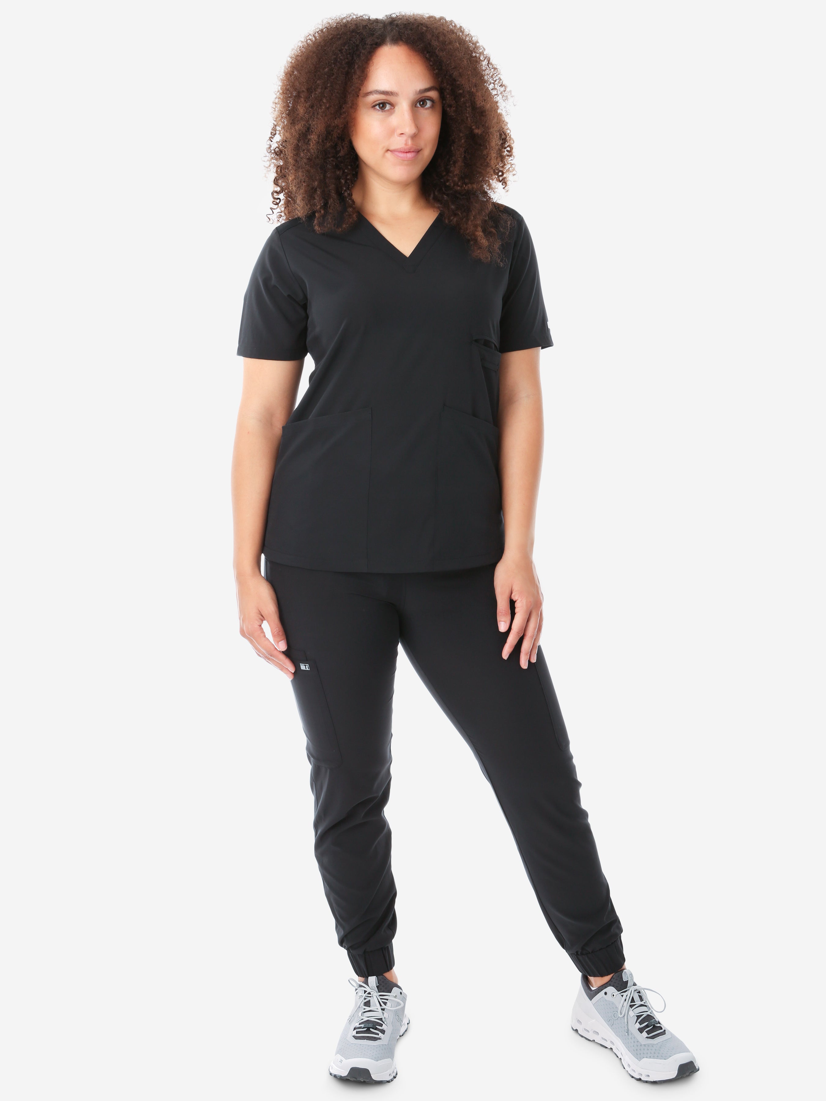 Women&#39;s Four-Pocket Scrub Top Real Black Top Full Body Front View with Joggers