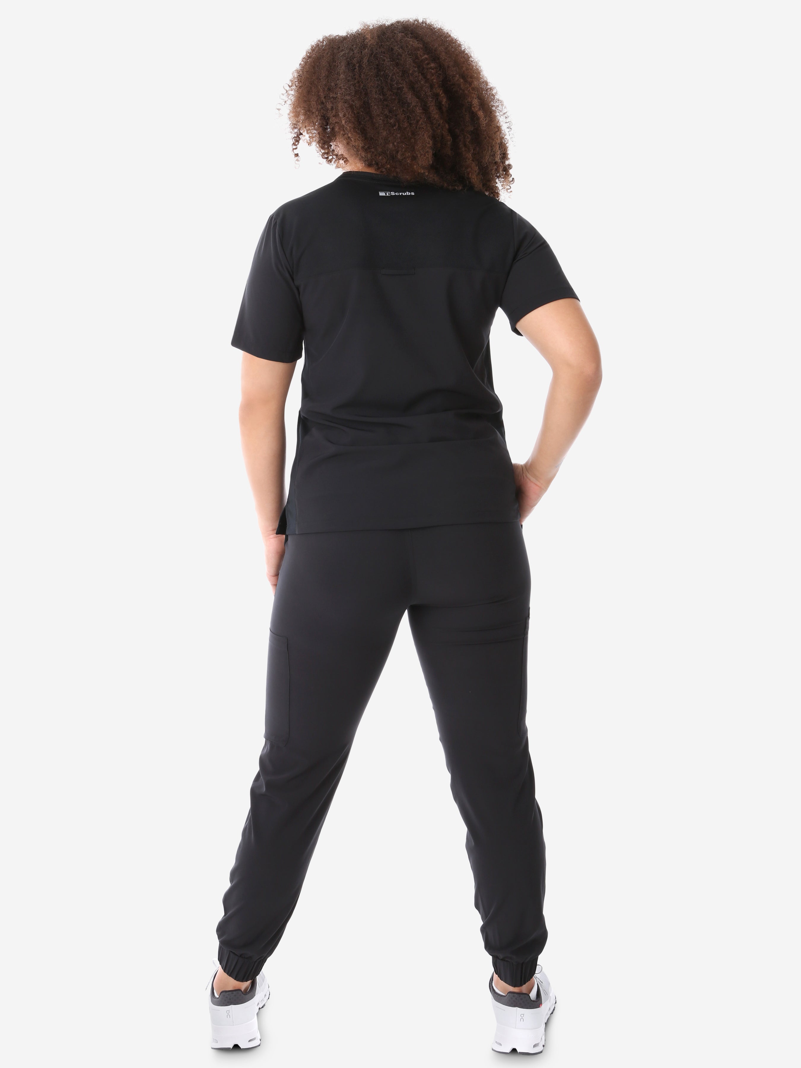 Women&#39;s Four-Pocket Scrub Top Real Black Top Full Body Back View with Joggers