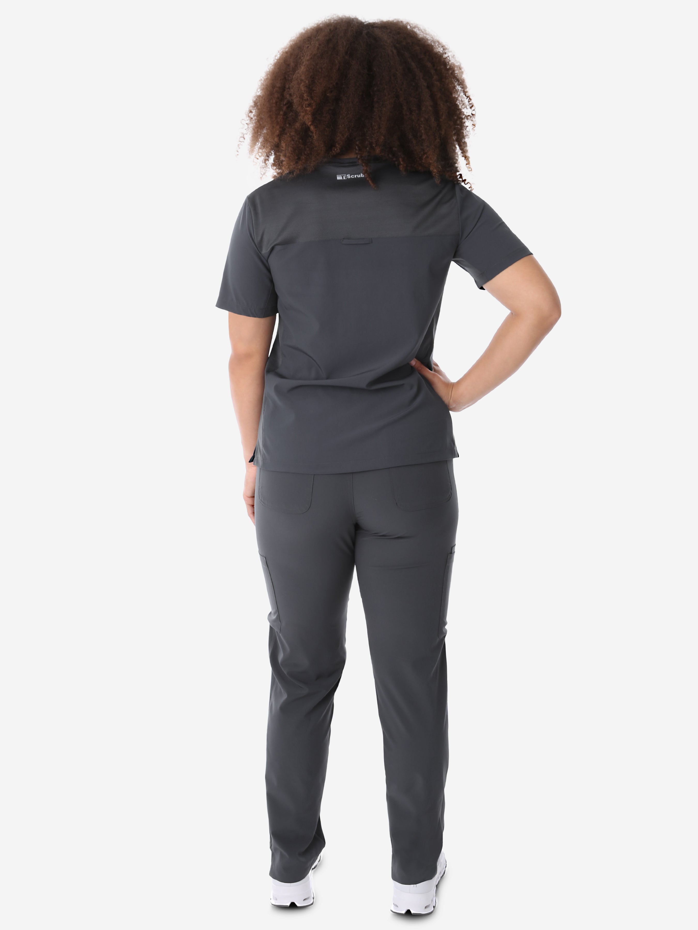 Women&#39;s Four-Pocket Scrub Top Charcoal Full Body Back View with 9-Pocket Pants