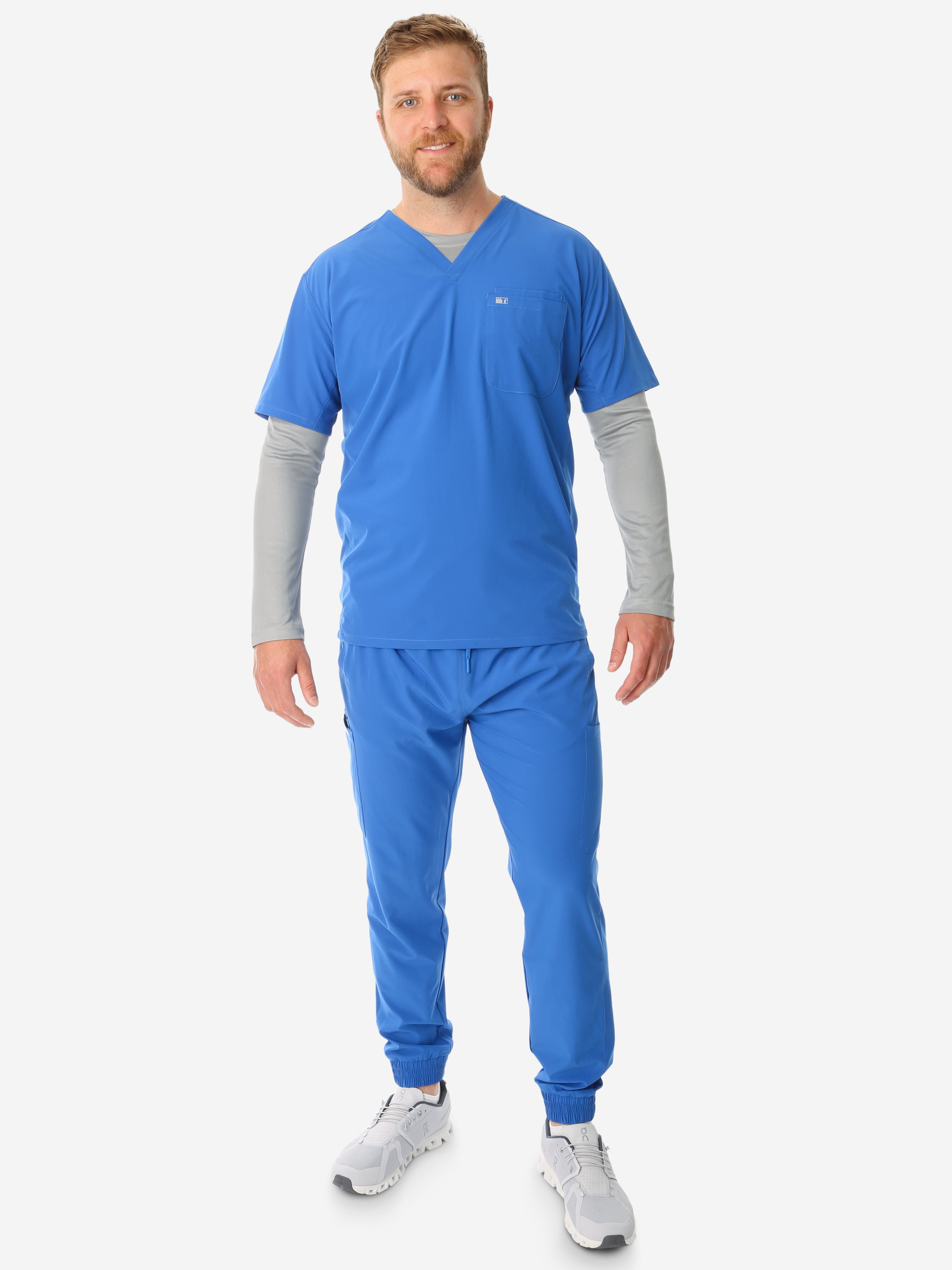 TiScrubs Men&#39;s Stretch Royal Blue Double-Pocket Scrub Top and Jogger Pants Full Body Front with Titanium Gray Underscrub