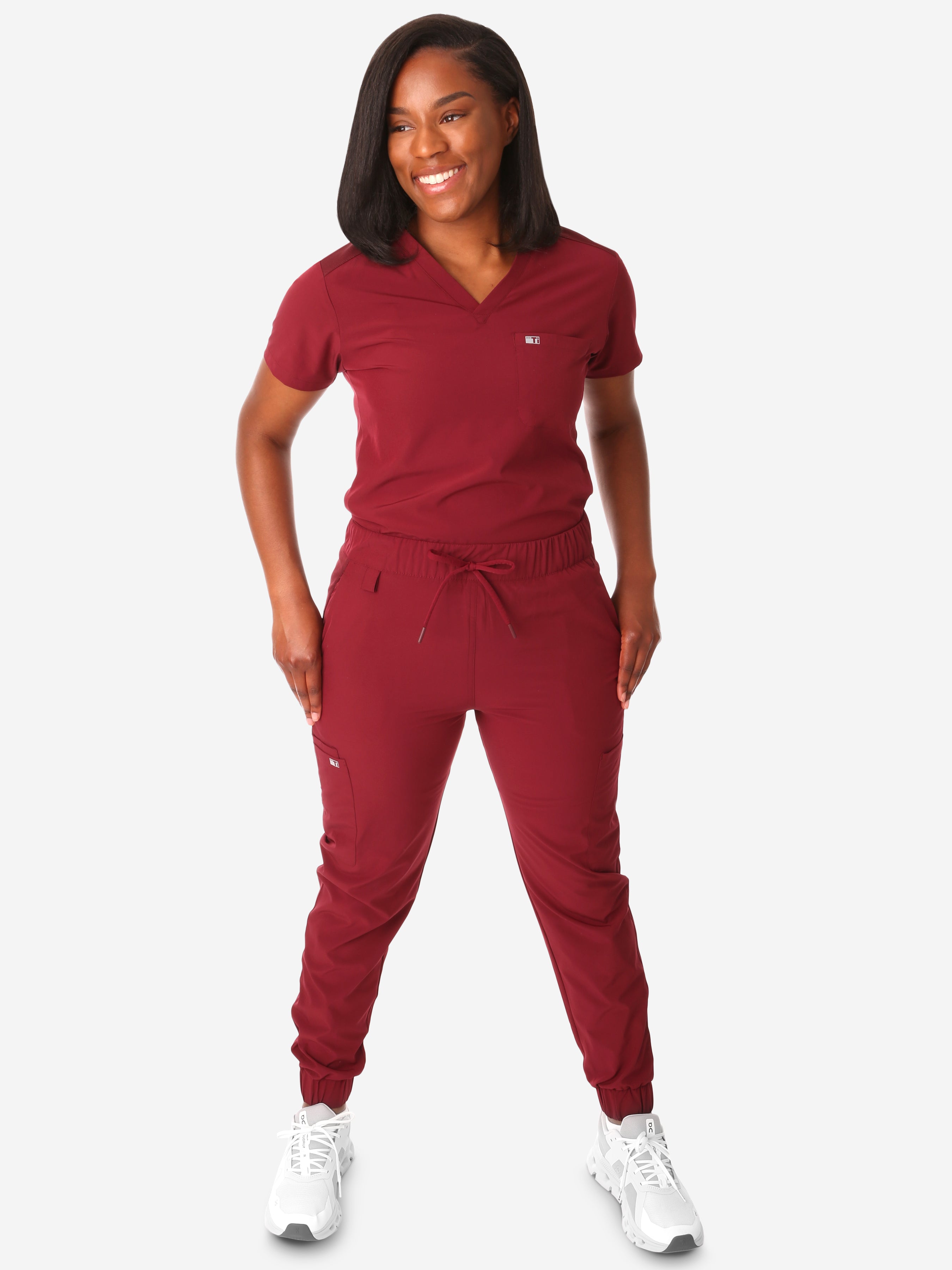 TiScrubs Women's Stretch Bold Burgundy One-Pocket Tuckable Scrub Top and 9-Pocket Pants Untucked  Full Body Front