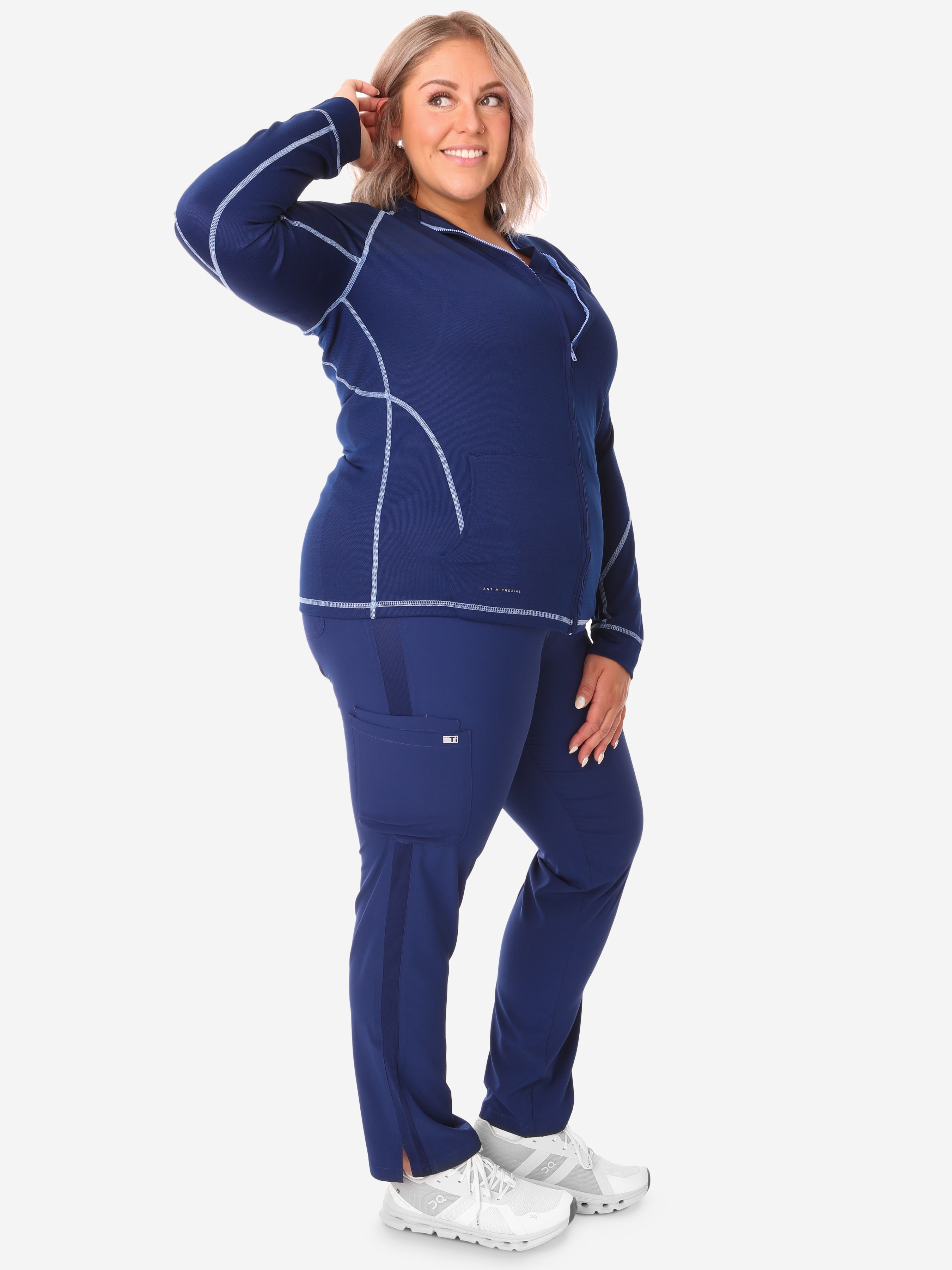 Women&#39;s Mesh Scrub Jacket Navy Blue Side View Full Body Plus Navy Stretch Scrubs