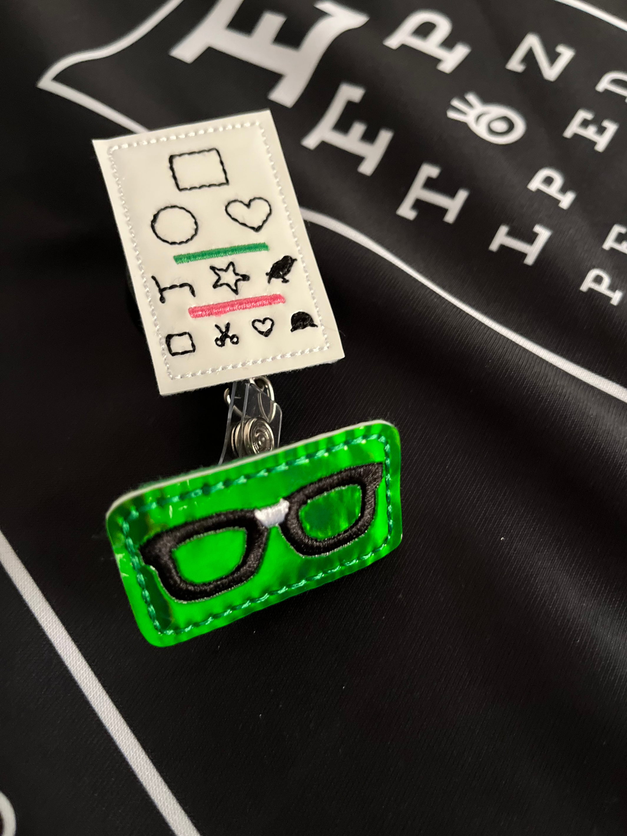 Badge Reel and Accessories Eye Chart and Eyeglassess on Black 20/20Vision Topn 