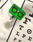 Green Glasses Badge Reel Accessory on White 20/20 Vision Scrub Top
