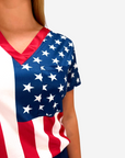 Women's American Flag Patriotic scrub top on model pocket closeup