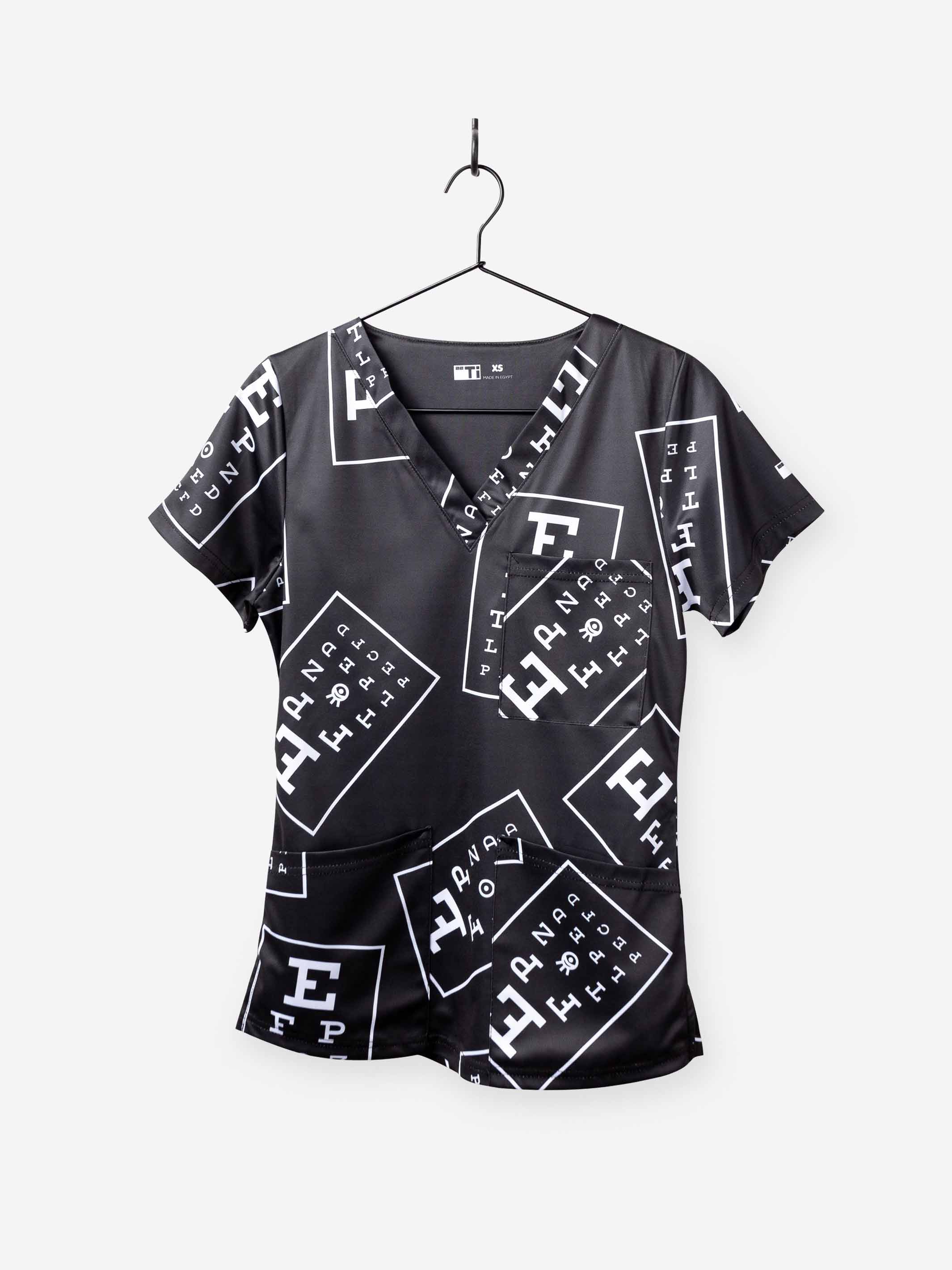 women's ophthalmology print scrub top black with white eye charts